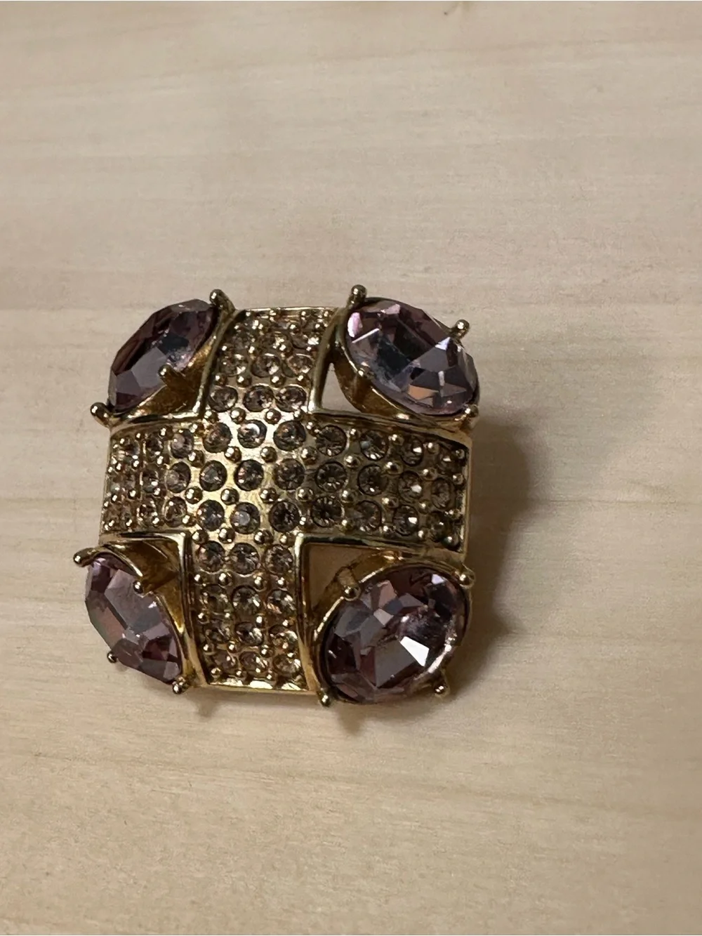Monet gold-tone brooch with an abstract geometric design with purple stones